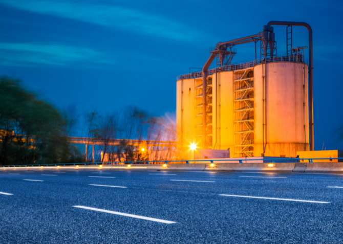 Oil Refinery Illuminated Under a Moonlit Sky