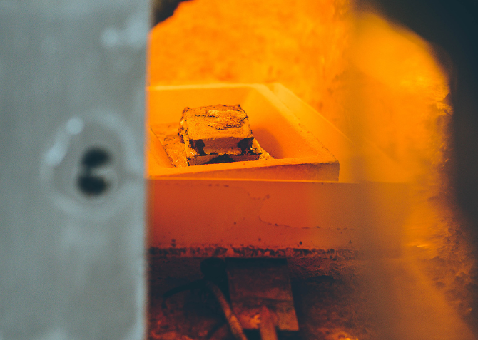 Golden rivers flow within the fiery crucible, molten dreams forged in the heart of industry.