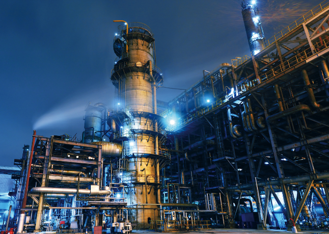 Illuminated Oil Refinery Under a Moonlit Sky